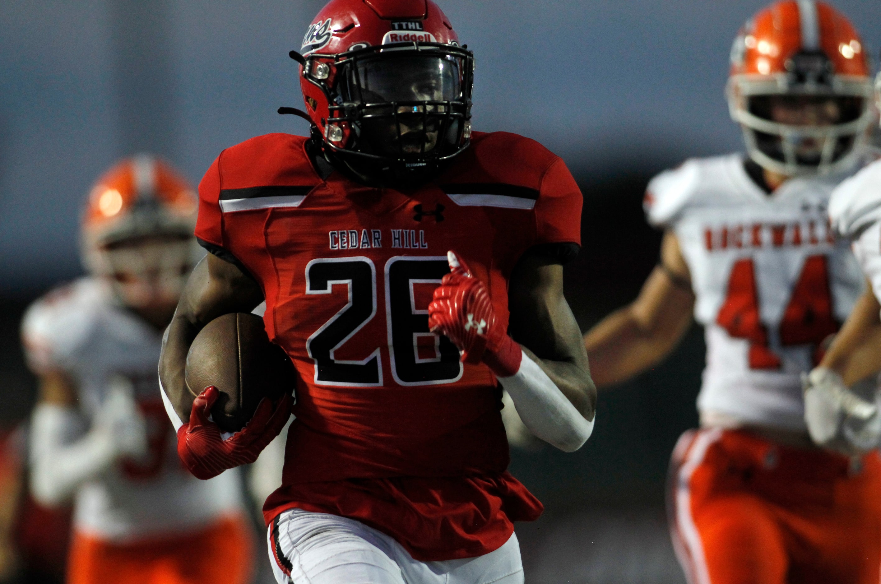 Cedar Hill running back Jaylen Jenkins (26) outruns a host of Rockwall defenders enroute to...