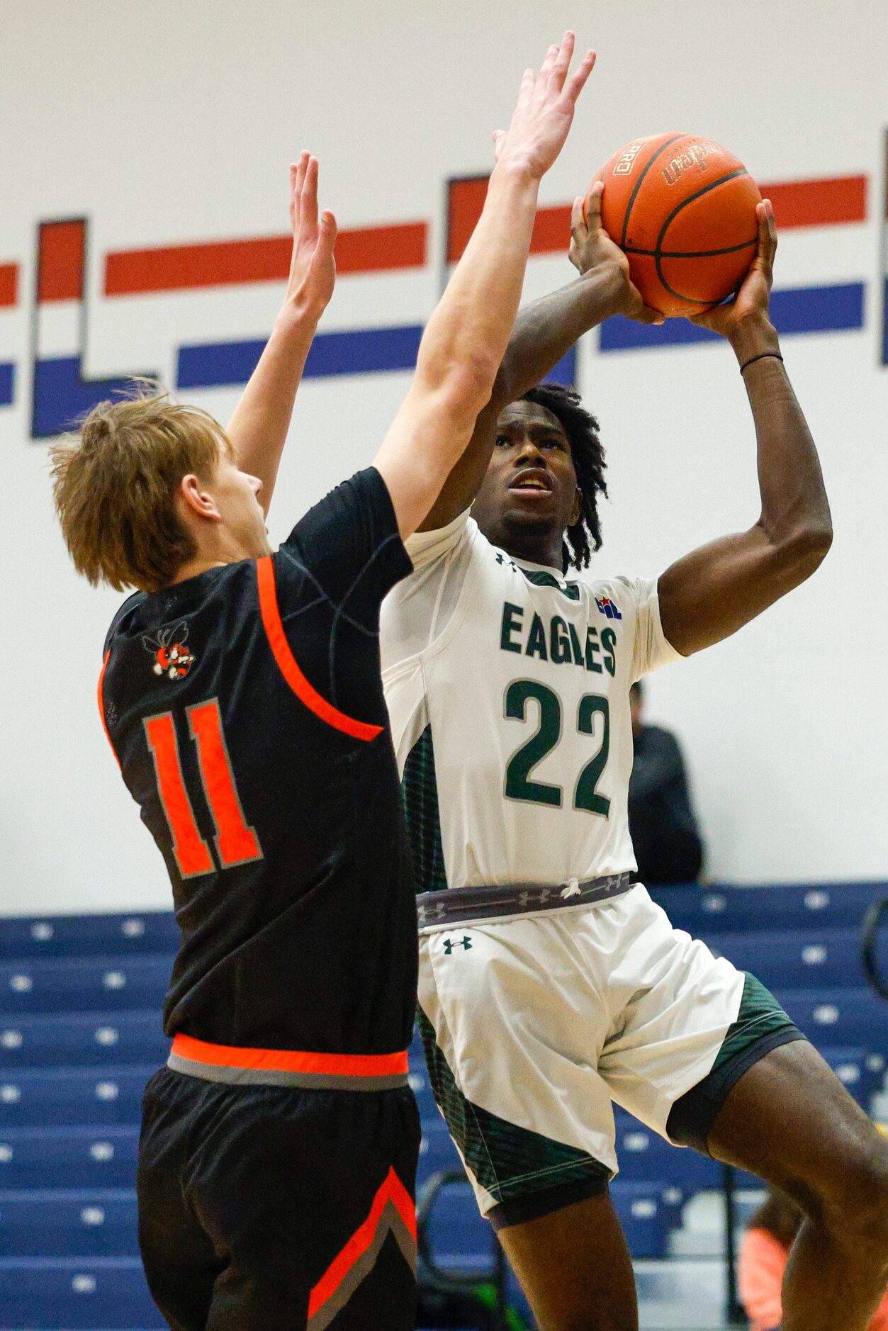 Mansfield Lake Ridge's Matthew Alexander (22) shoots over Rockwall's Corbin Brown (11)...