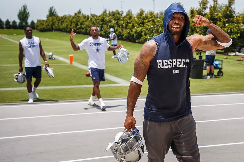 Dallas Cowboys' Tavon Austin flexes his muscles as he walks off the field following practice...
