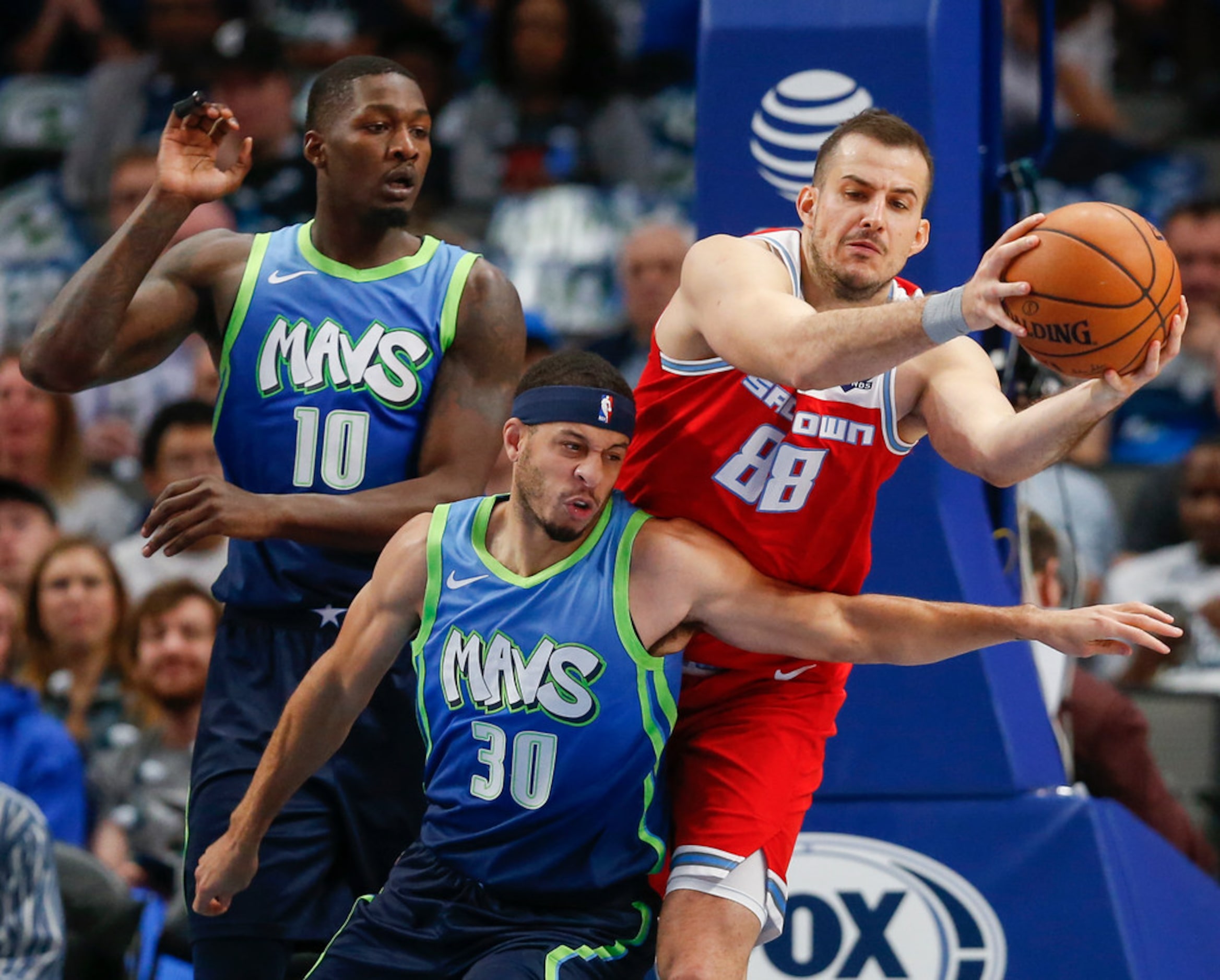 Dallas Mavericks forward Dorian Finney-Smith (10) and guard Seth Curry (30) battle with...