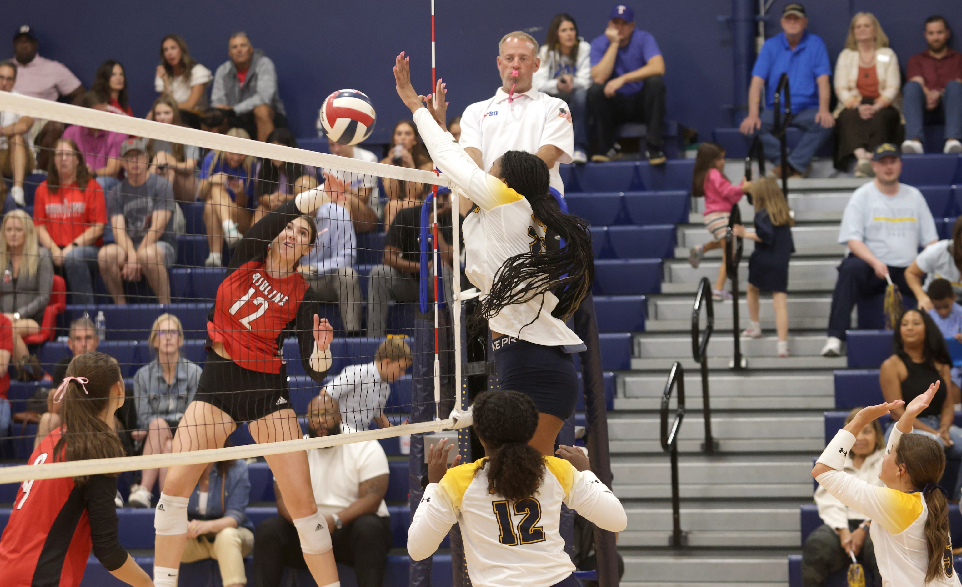 Ursuline player #12 Sophia Thornburg returns for the ball as Prestonwood player #23 Macaria...