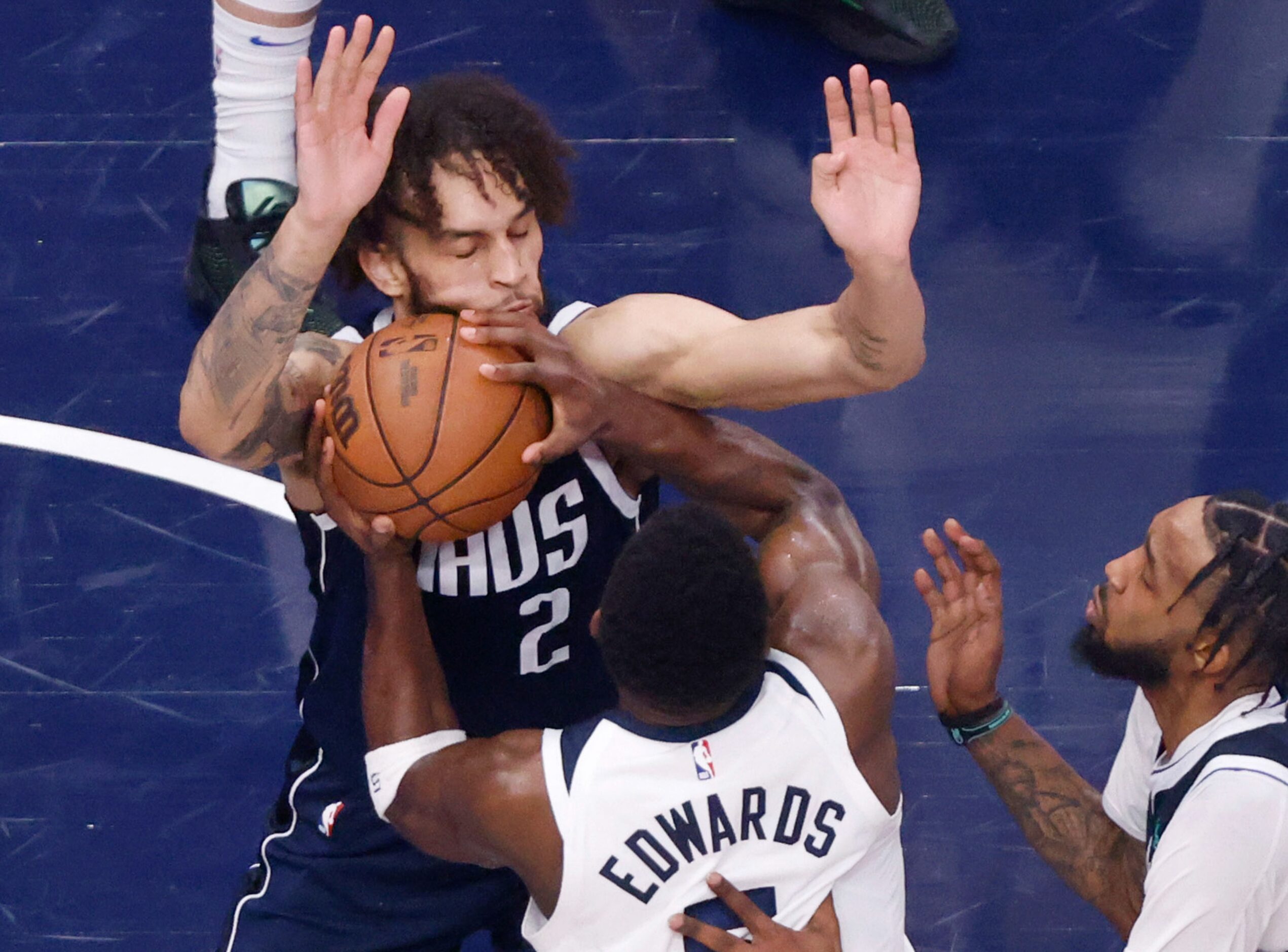 Dallas Mavericks center Dereck Lively II (2) takes a shot to the face from Minnesota...