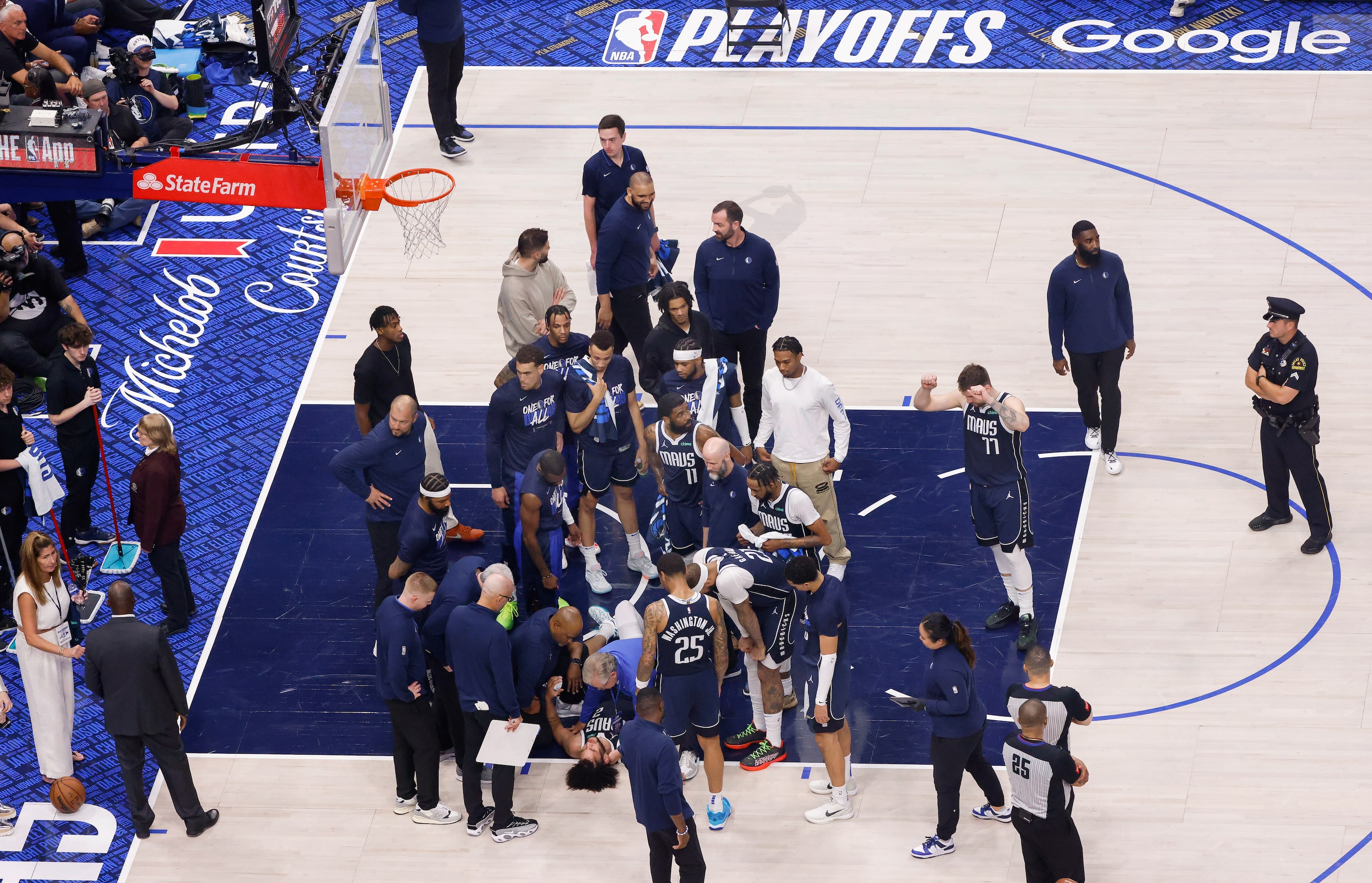 Dallas Mavericks center Dereck Lively II (2) holds his head after sustaining an injury...