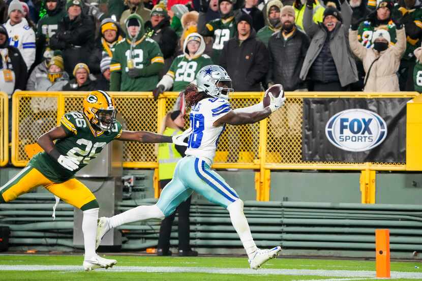 Dallas Cowboys wide receiver CeeDee Lamb (88) scores on a 35 yard-touchdown pass as Green...
