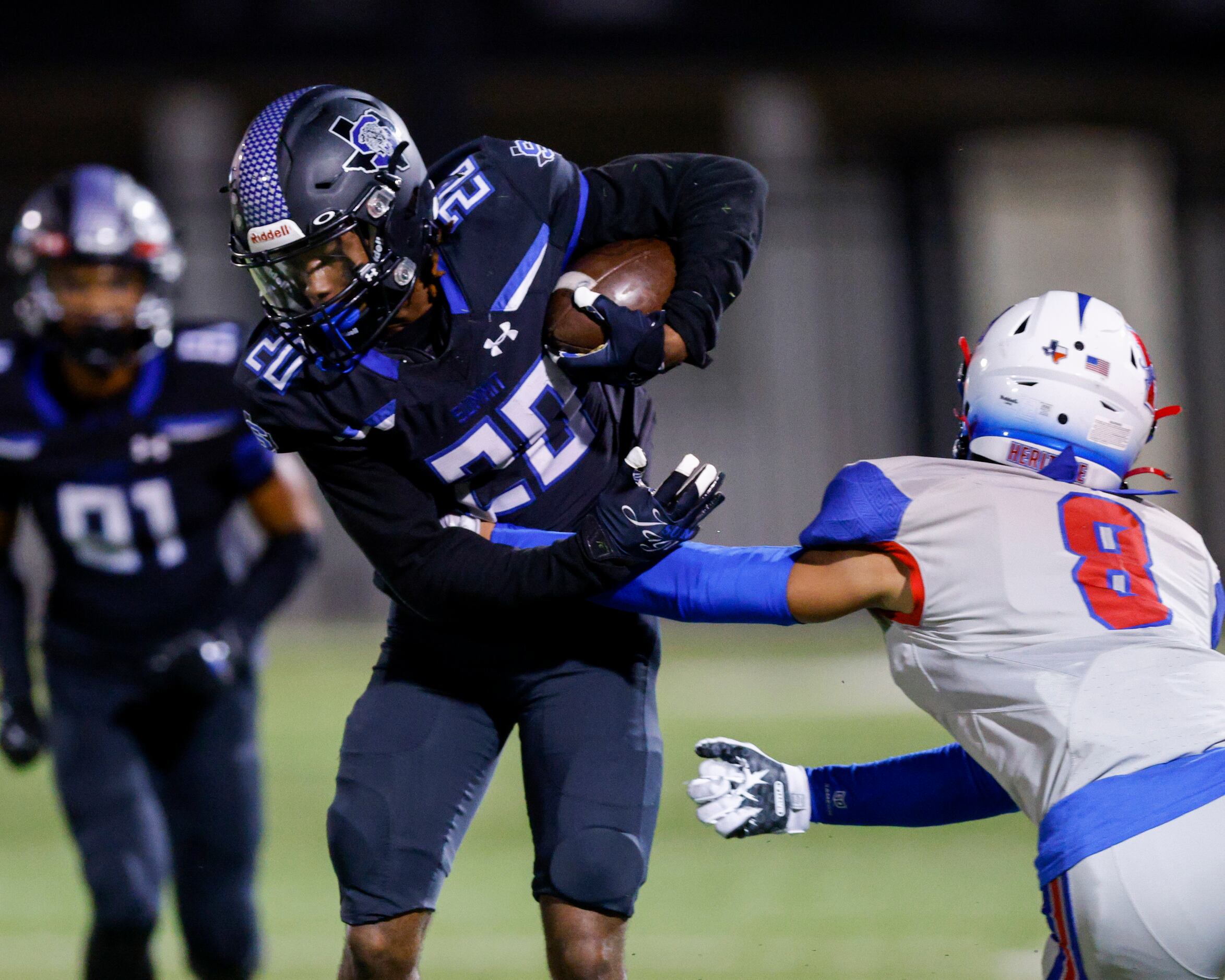 Mansfield Summit’s Davaughn Sille (20) runs through the arm of Midlothian Heritage defensive...