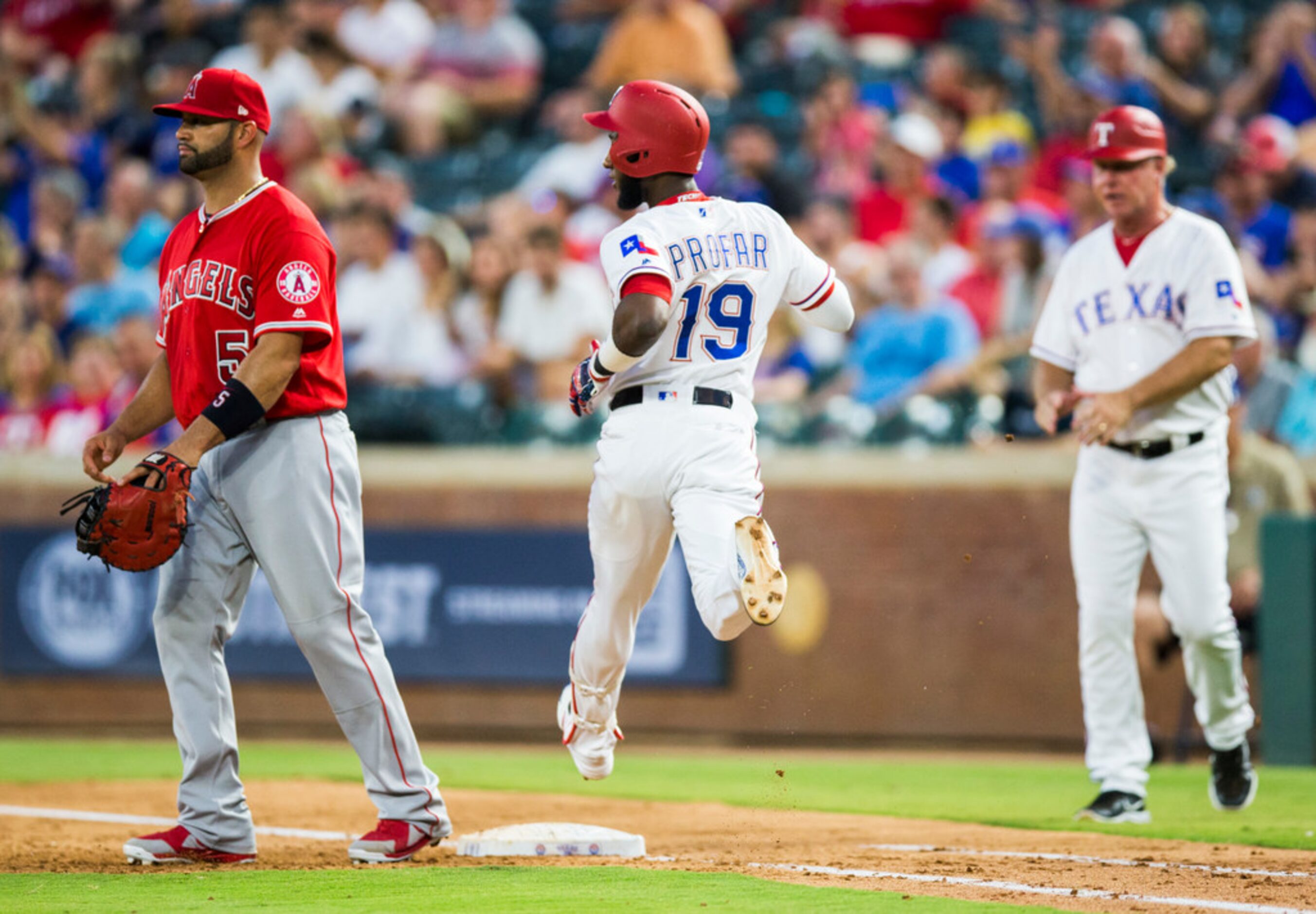 Texas Rangers shortstop Jurickson Profar (19) makes it to first after a hit during the third...