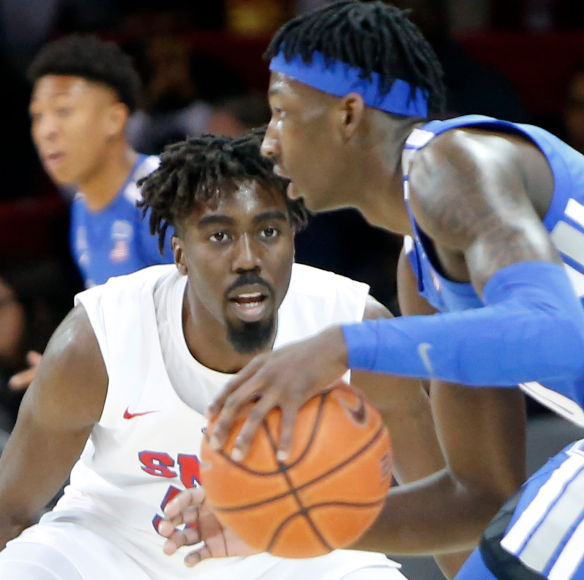 SMU guard Emmanuel Bandoumez (5) applies aggressive defense as Memphis guard Damion Blaugh...