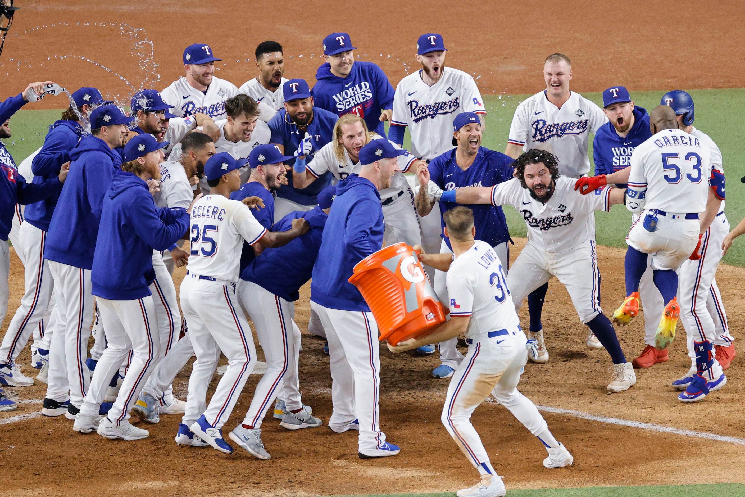 Texas Rangers right fielder Adolis Garcia (53) celebrates with his teammates after hitting a...