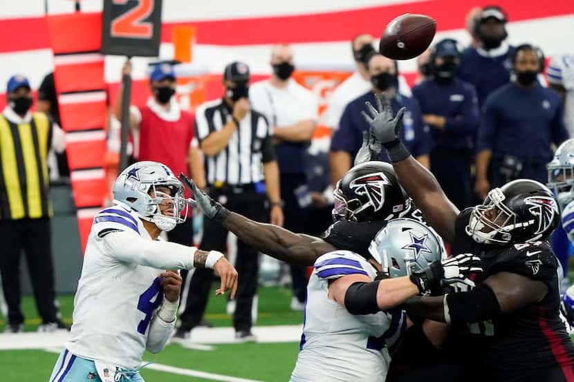 FILE - Cowboys quarterback Dak Prescott completes a 24-yard pass to wide receiver CeeDee...