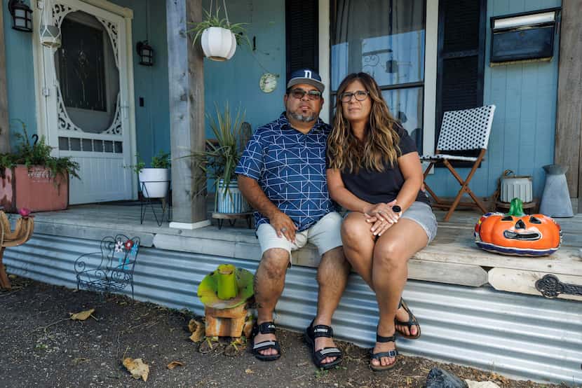 Eddie Aragonez (left) sits with his wife Alma Aragonez on the front porch of their home...