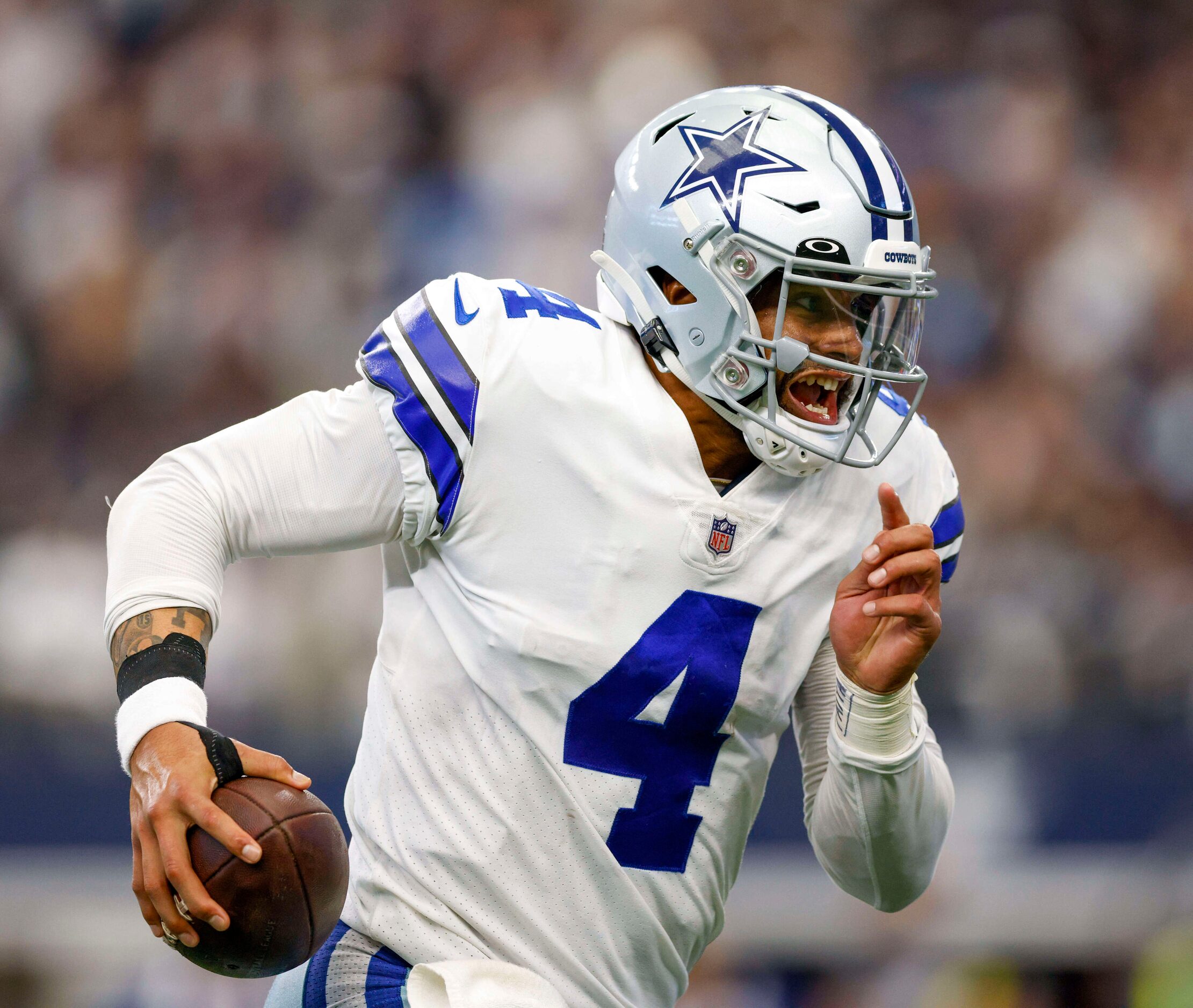 Dallas Cowboys quarterback Dak Prescott (4) runs the ball during the fourth quarter of a NFL...