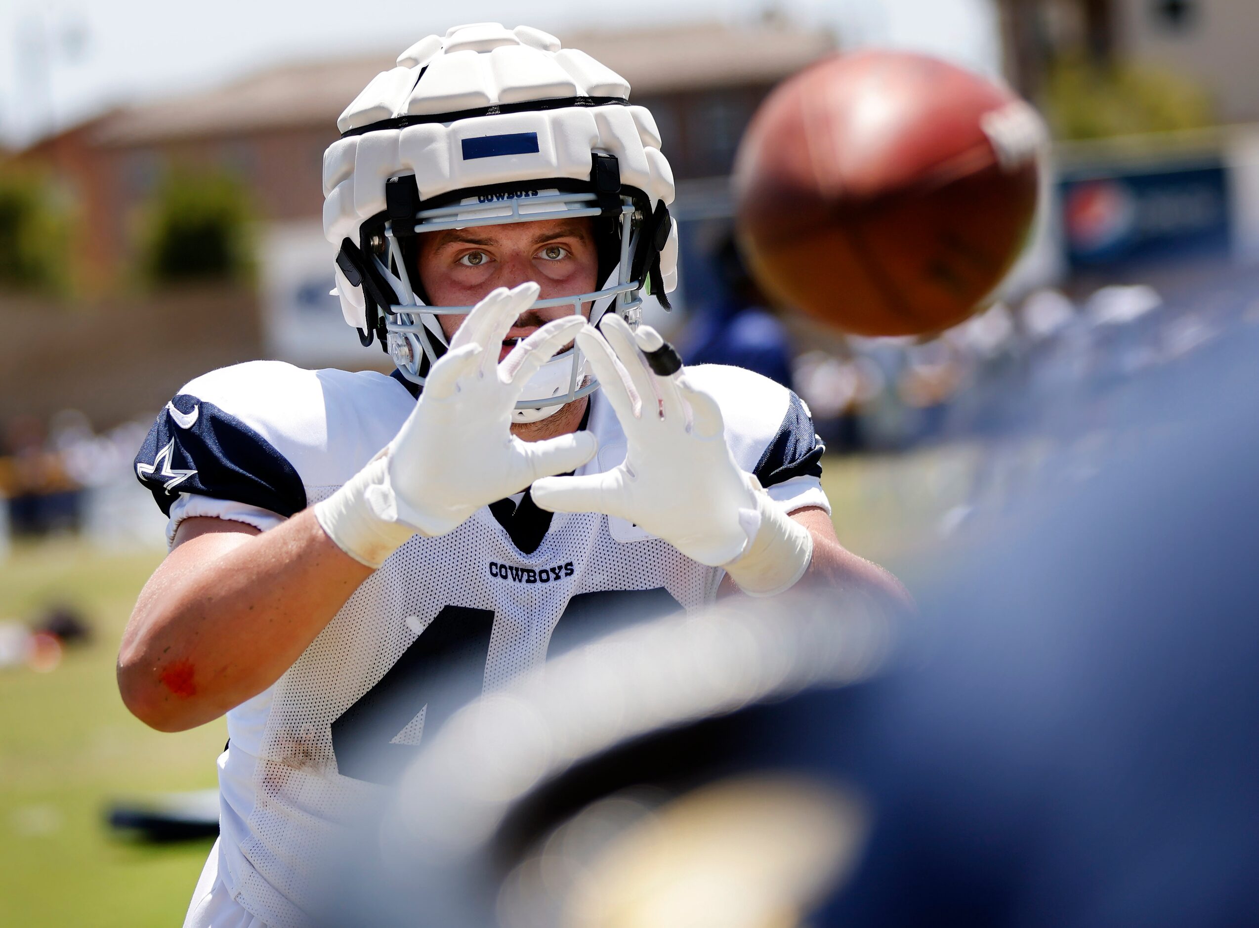 Dallas Cowboys tight end Jake Ferguson (48) catches footballs thrown form a machine during...