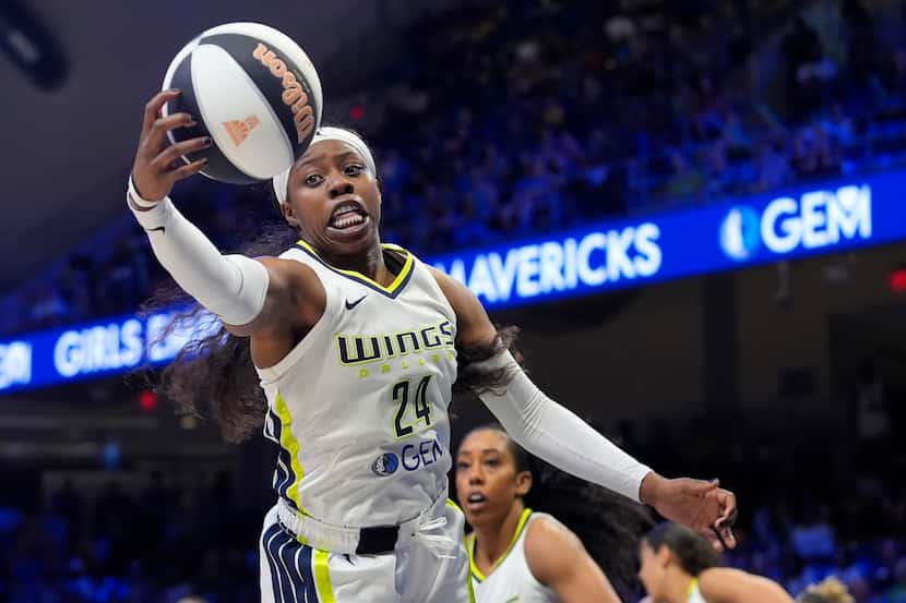 Dallas Wings guard Arike Ogunbowale (24) reaches for a rebound during the first half of the...