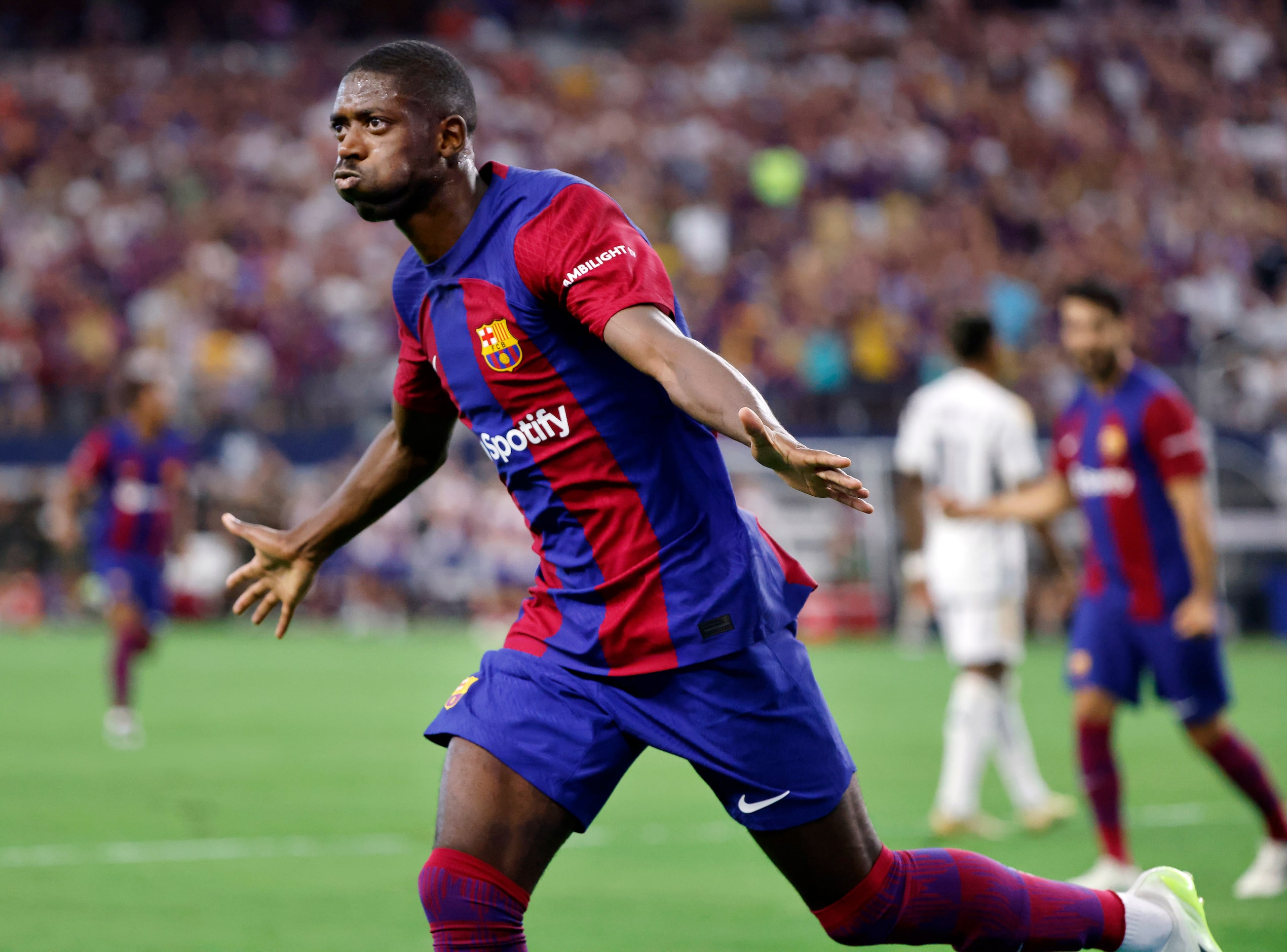 Barcelona forward Ousmane Dembélé (7) celebrates his first half score on Real Madrid...