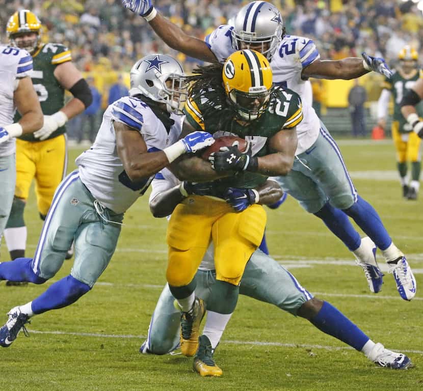 Green Bay Packers running back Eddie Lacy (27) fights for extra yardage as Dallas Cowboys...