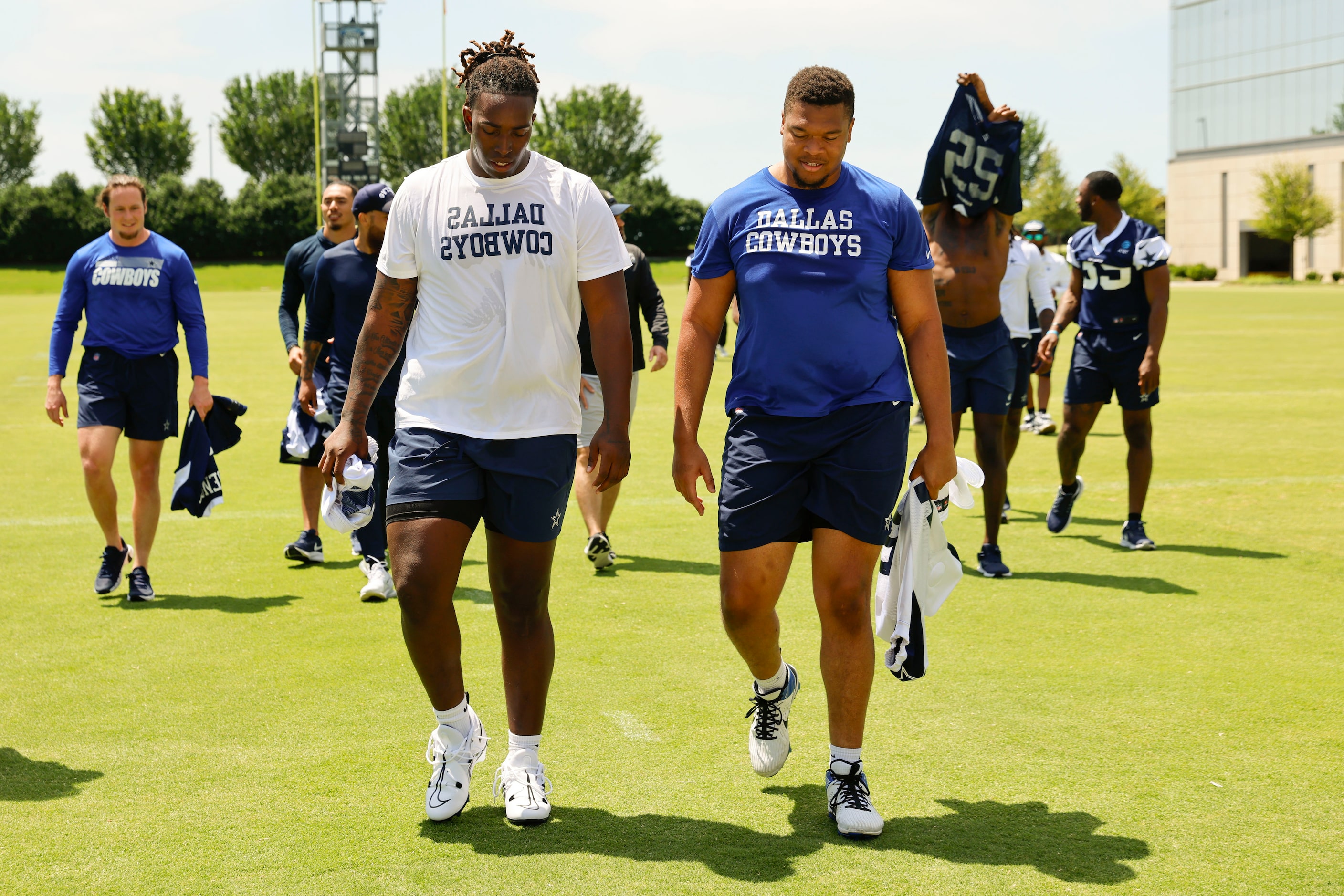 Dallas Cowboys offensive line Tyler Guyton (left) and Earl Bostick exit the field following...