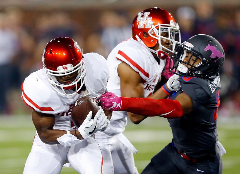 Houston Cougars quarterback D'Eriq King (4) is able to pull in a first quarter pass despite...