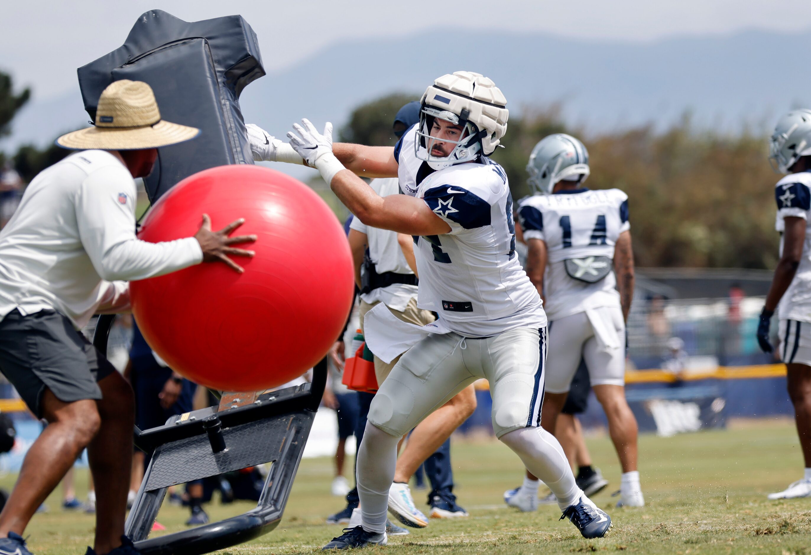 Dallas Cowboys tight end Sean McKeon (84) pushes off the blocking sled before catching a red...