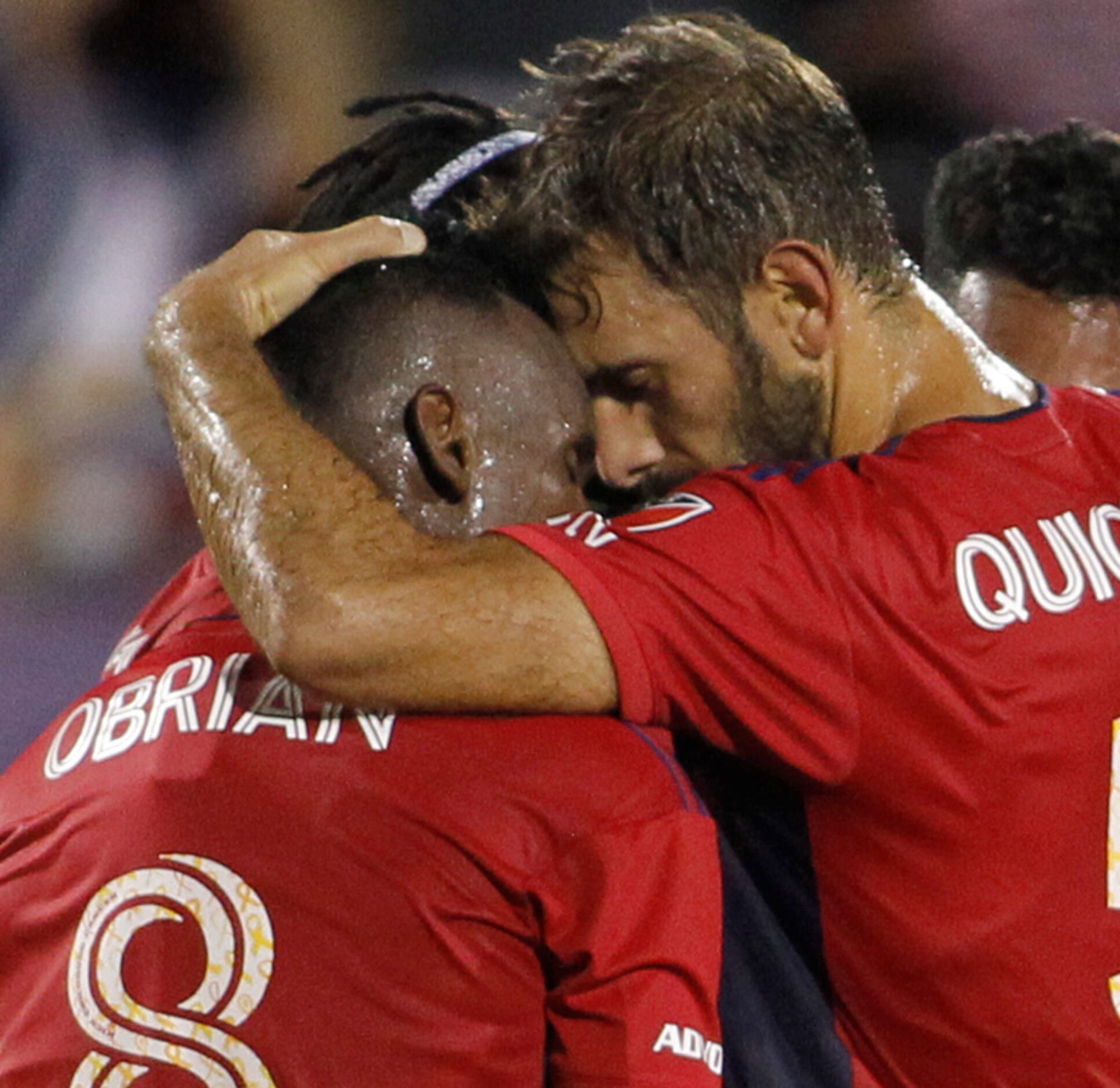 FC Dallas attacker Jader Obrian (8) receives a hug from midfielder Fecundo Quignon (5) after...