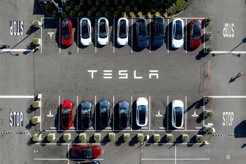Tesla vehicles line a parking lot at the company's Fremont, Calif., factory.