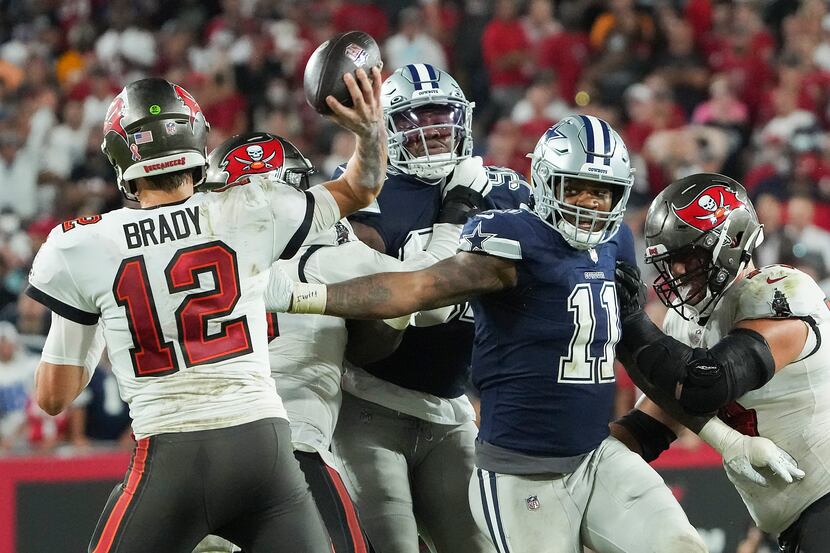 Tampa Bay Buccaneers quarterback Tom Brady (12) throws a pass under pressure from Dallas...