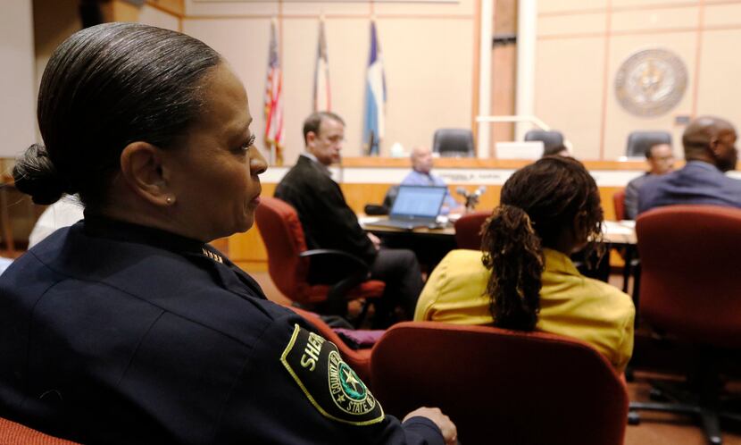 Interim Dallas County Sheriff Marian Brown (left) listens as Dallas County Commissioner John...
