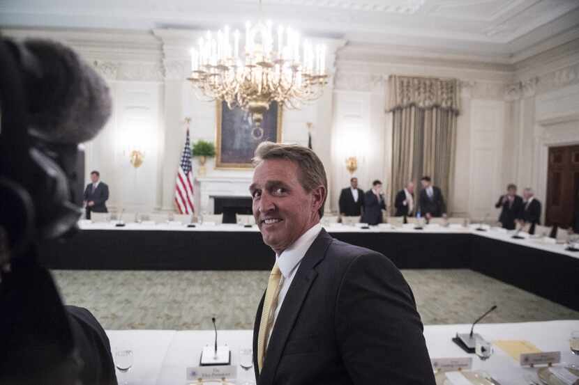 Sen. Jeff Flake arrives at the White House for a Senate GOP luncheon with President Trump...