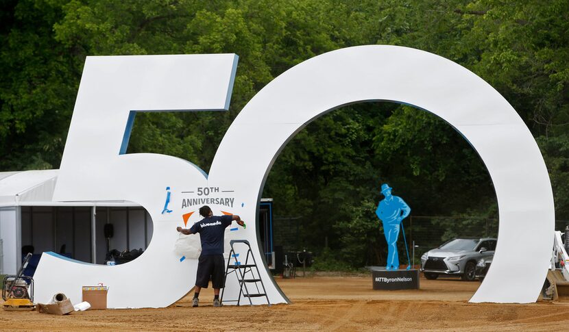 Brandon Barnes puts up a sign before the AT&T Byron Nelson kicks off at Trinity Forest Golf...