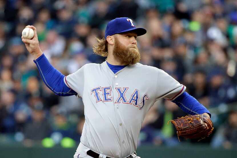 Texas Rangers starting pitcher Andrew Cashner throws against the Seattle Mariners during the...