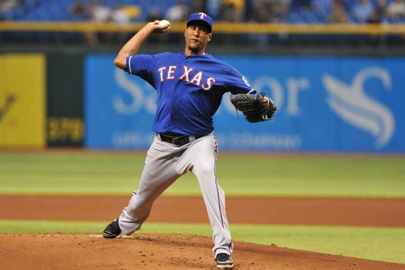 ST. PETERSBURG, FL - SEPTEMBER 17: Pitcher Alexi Ogando #41  the Texas Rangers throws in the...