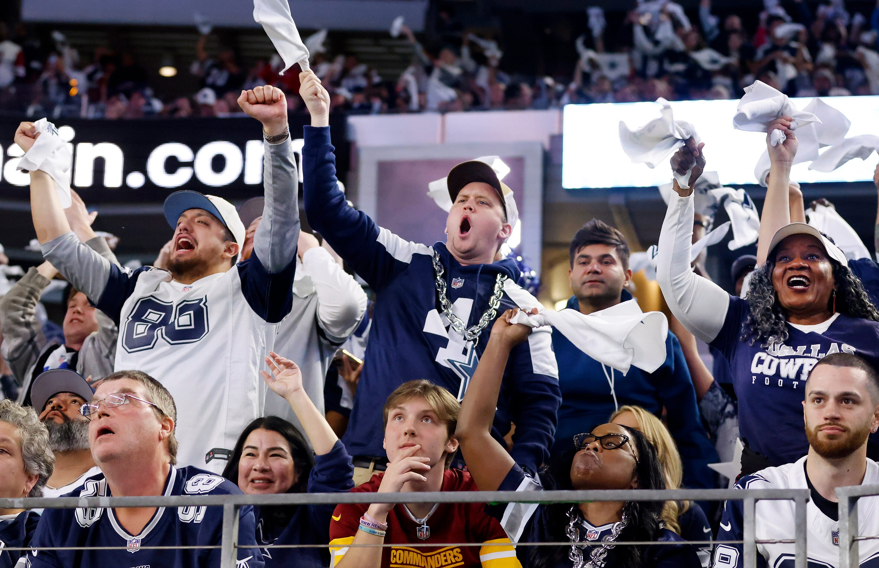 Dallas Cowboys fans cheer as the team took a commanding lead over the Washington Commanders...