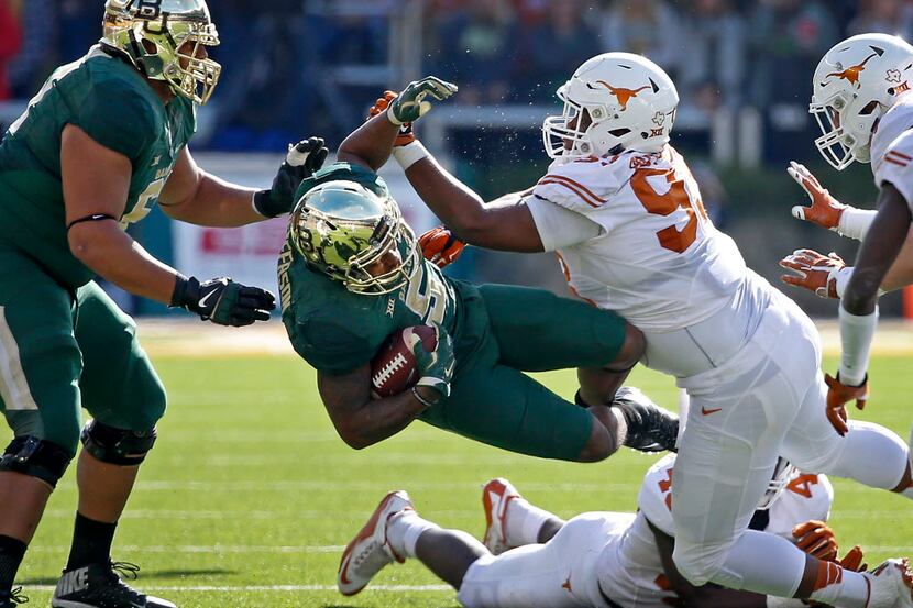 Baylor running back Johnny Jefferson (5) is hit by Texas defensive tackle Paul Boyette Jr....