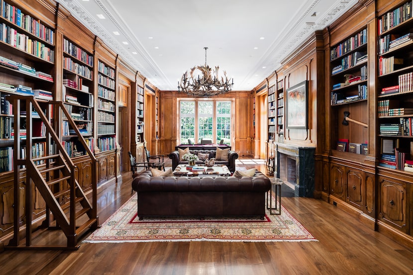 In the main house, the library features 200-year-old wood paneling from France. "Both the...