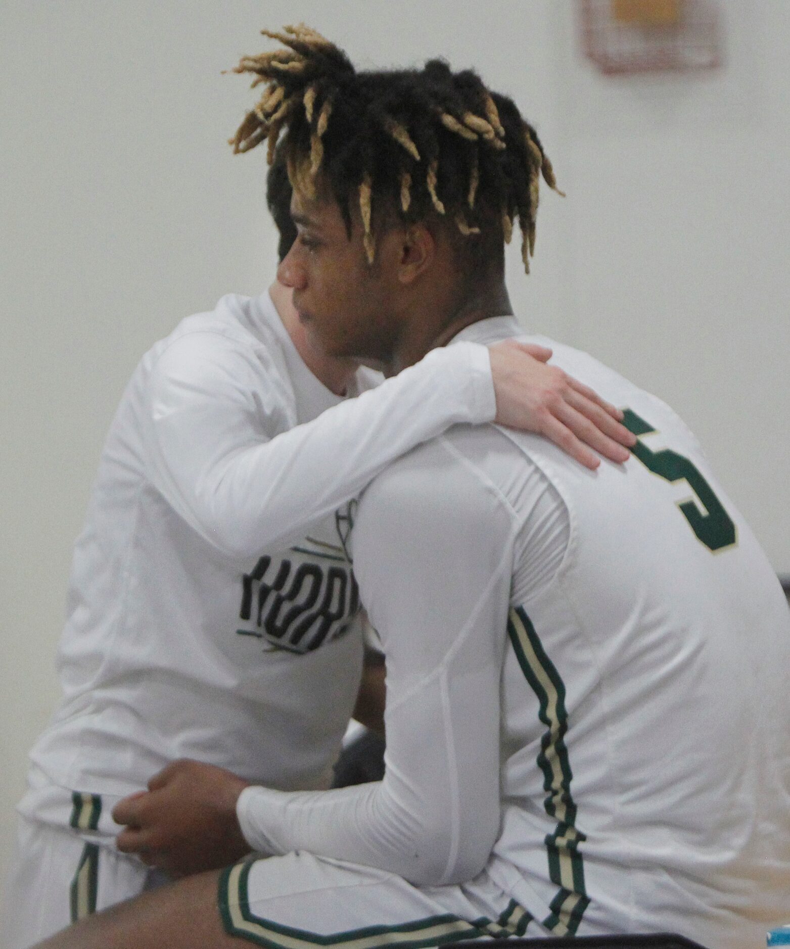 Greenhill's Micah Robinson (5) is consoled by a teammate following the team's 56-55 loss to...