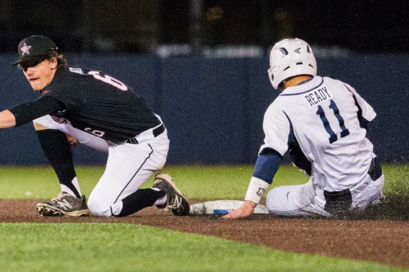Coppell's Jacob Nesbit (6) catches a throw to first base as Jesuit's Mark Ready (11) slides...