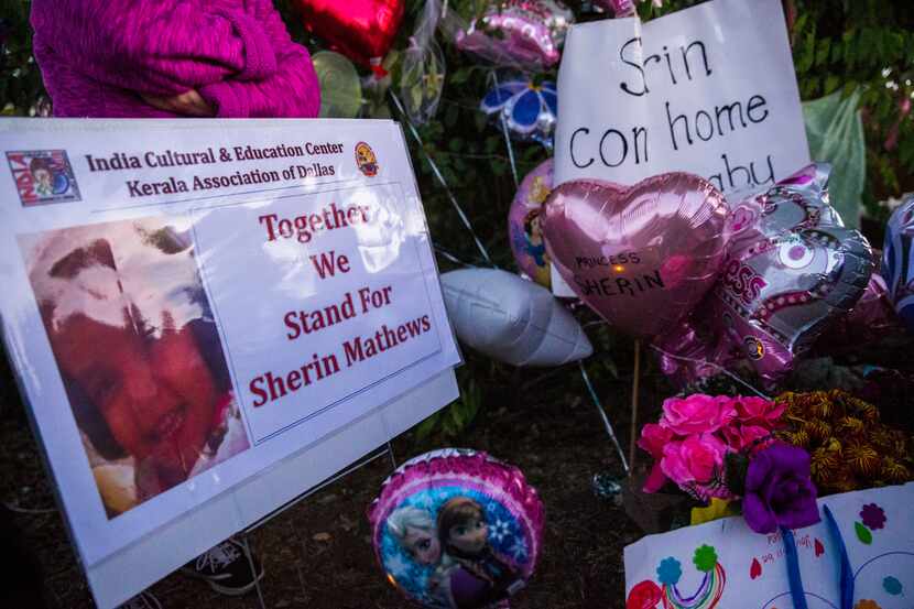 Signs, flowers, balloons and other items collected at a memorial for 3-year-old Sherin...