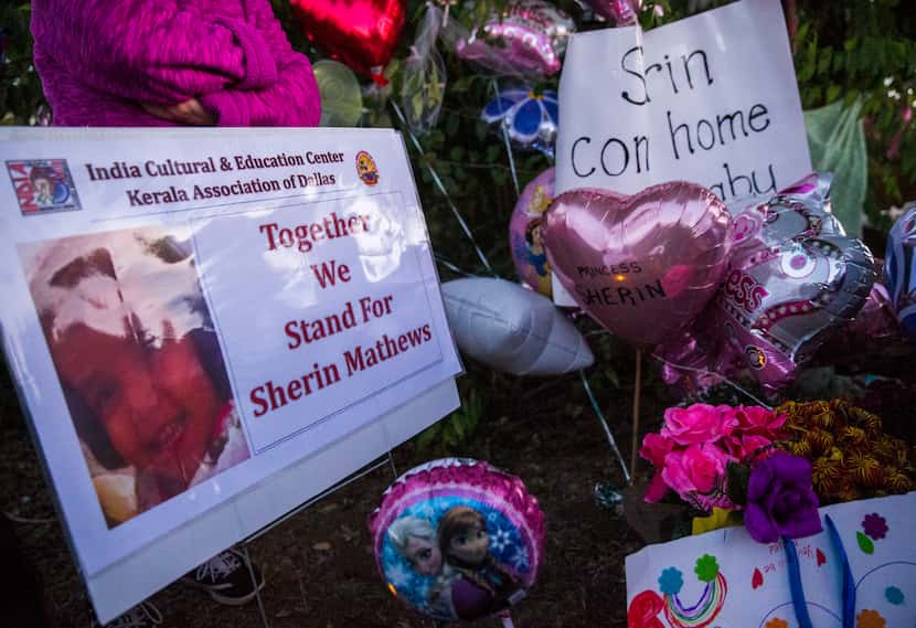 Signs, flowers, balloons and other items collect at a memorial for 3-year-old Sherin Mathews...