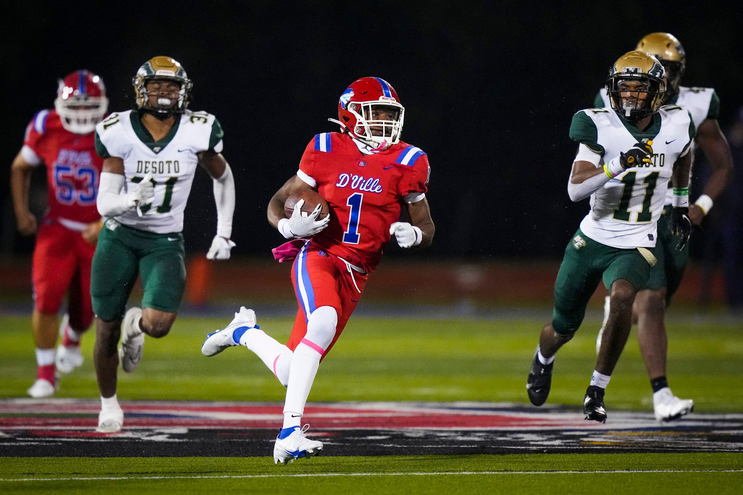 Duncanville wide receiver Lontrell Turner (1) races past DeSoto linebacker Brandon Booker...