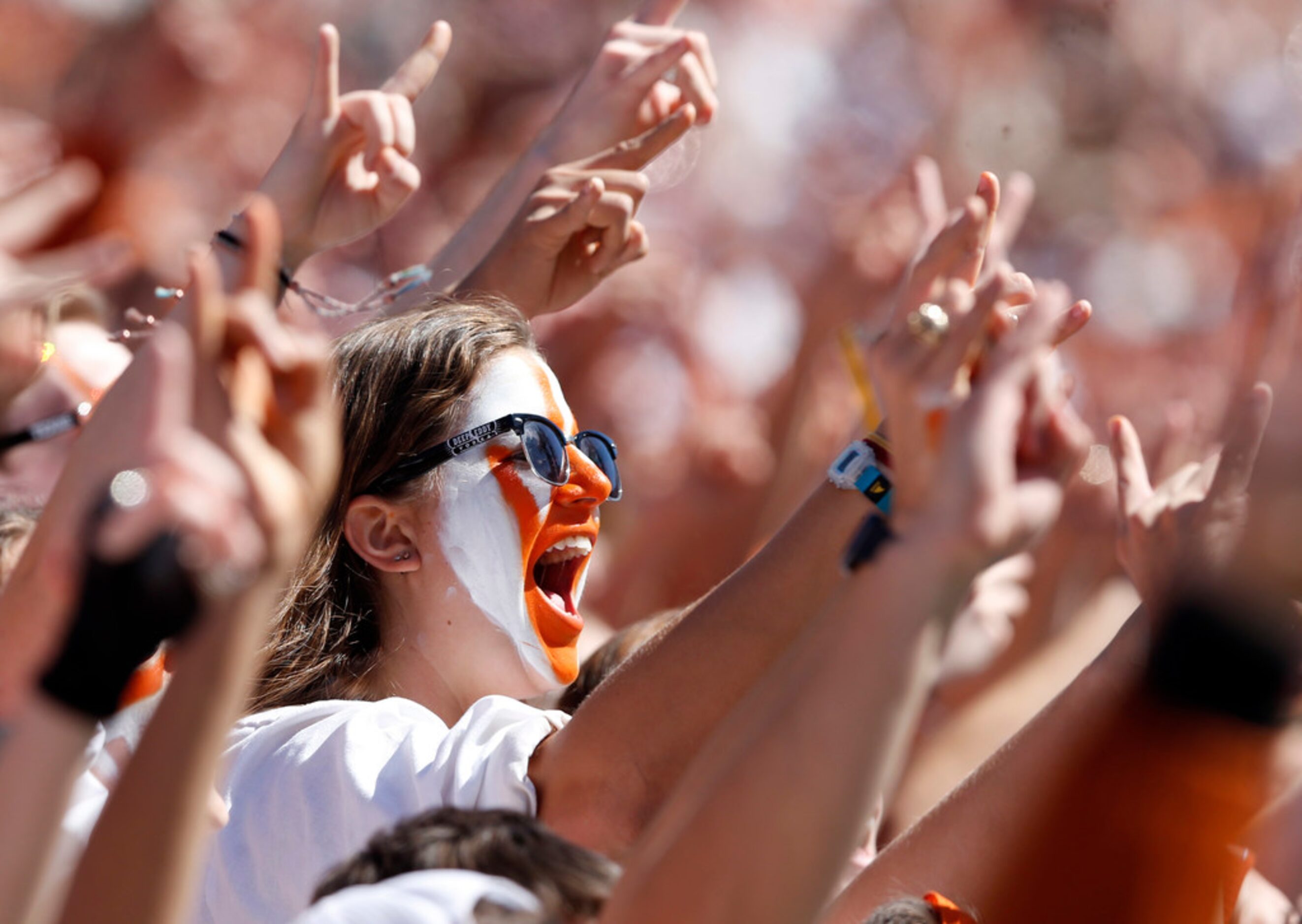 Texas Longhorns fans cheer on their team in a game against the Oklahoma Sooners during the...