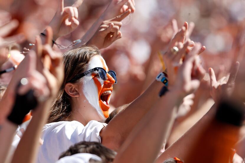 Texas Longhorns fans cheer on their team in a game against the Oklahoma Sooners during the...