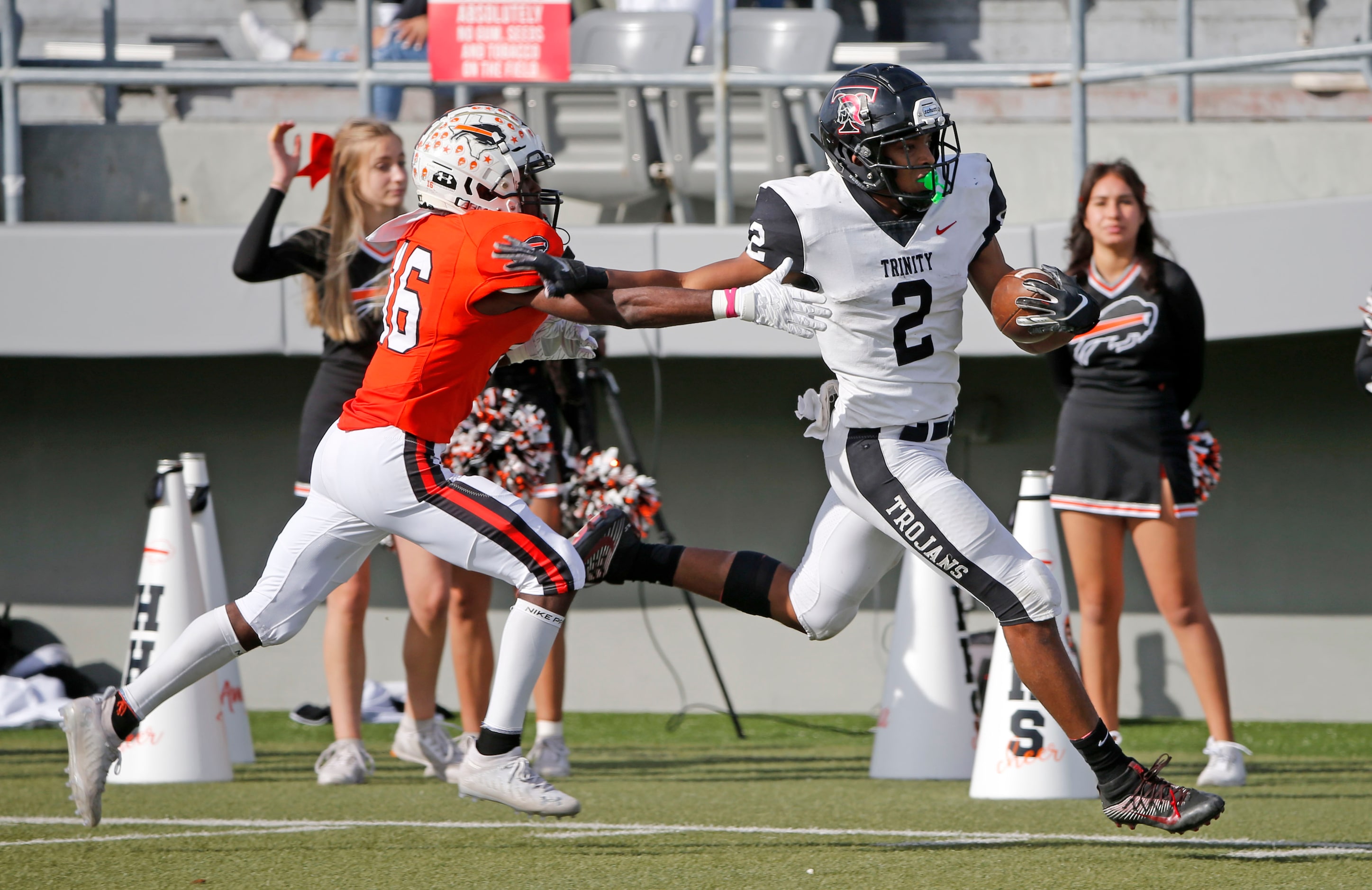 Euless Trinity running back Ollie Jordon (2) gets past Haltom defensive back Bryson Hicks...