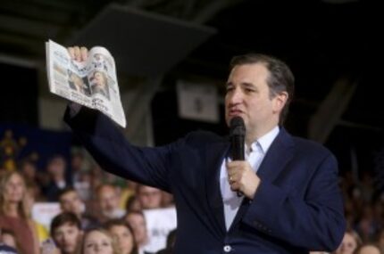  Sen. Ted Cruz holds a copy of USA Today as he tells a campaign rally in Knightstown, Ind.,...