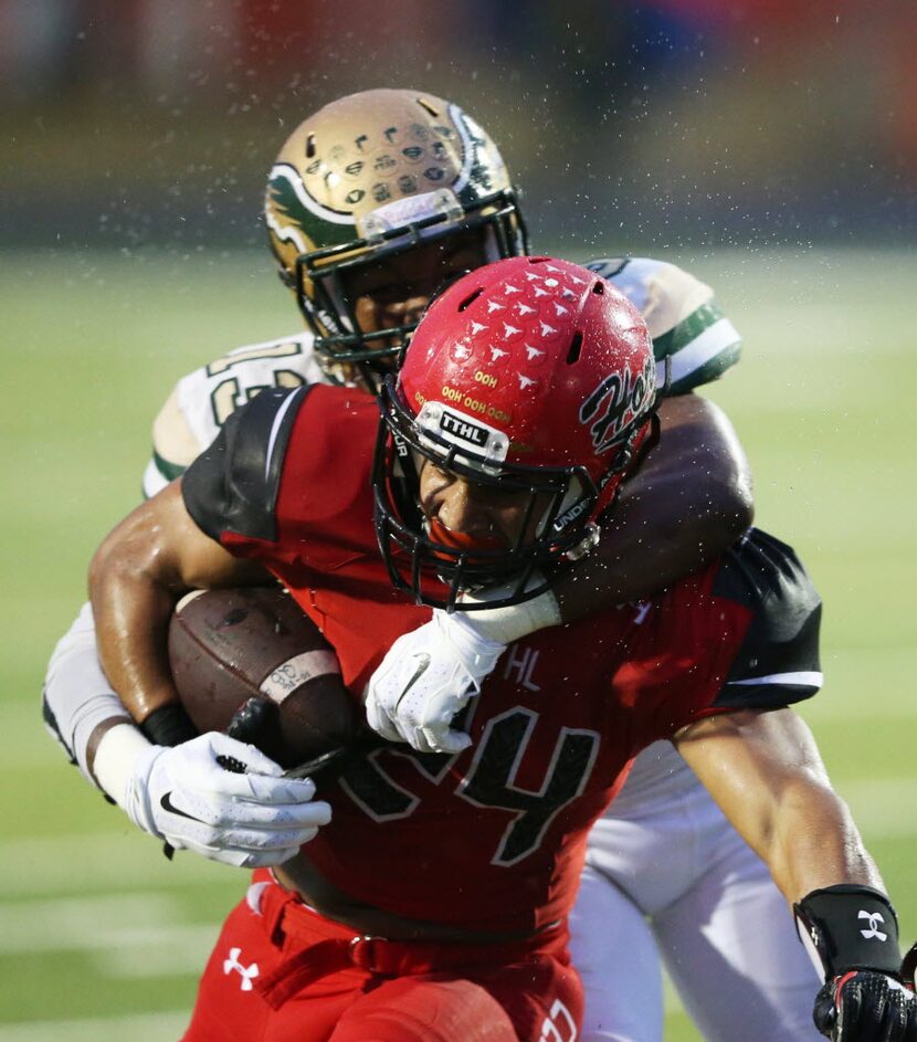 Cedar Hill's Kaegun Williams (24) is tackled by DeSoto's Isaiah Stewart (13) during the...