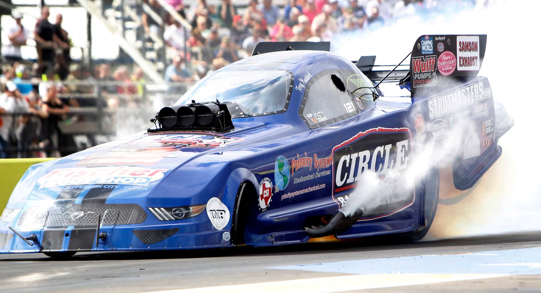 Funny Car driver Terry Haddock spins his tires before the start of his opening round race....