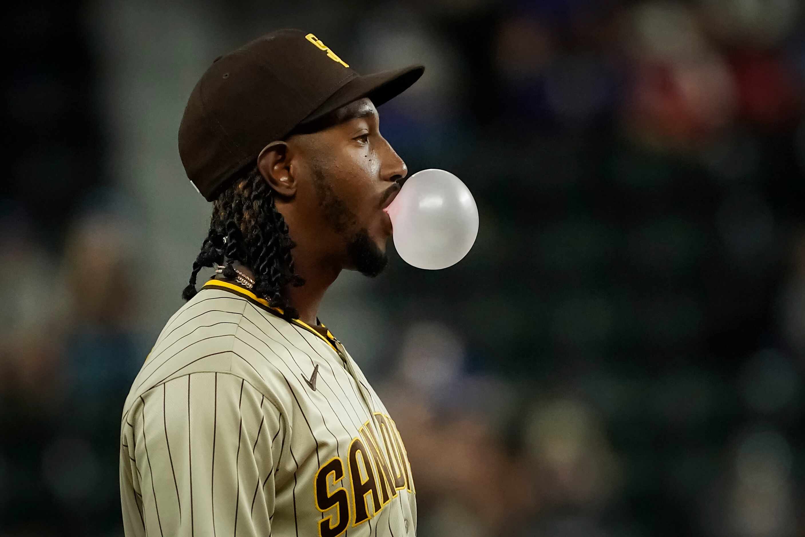 San Diego Padres third baseman Jorge Mateo blows a bubble between pitches during the ninth...