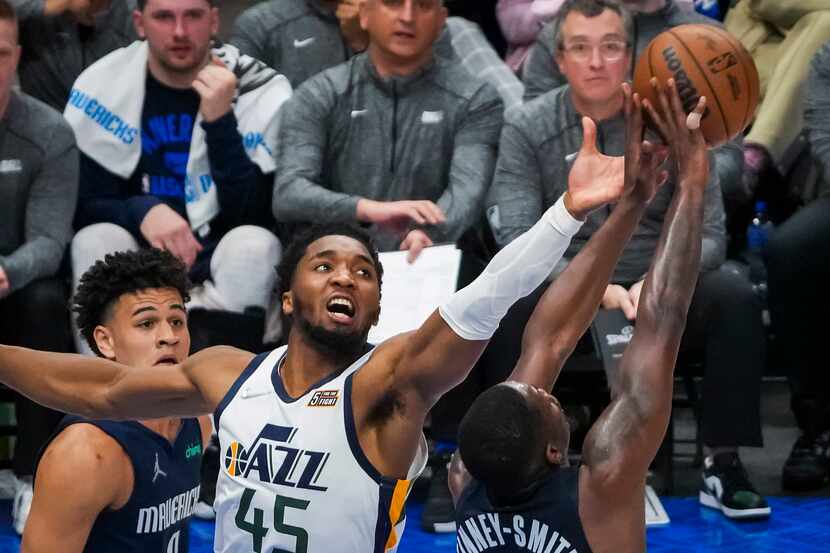 Dallas Mavericks forward Dorian Finney-Smith (10) takes a rebound away from Utah Jazz guard...