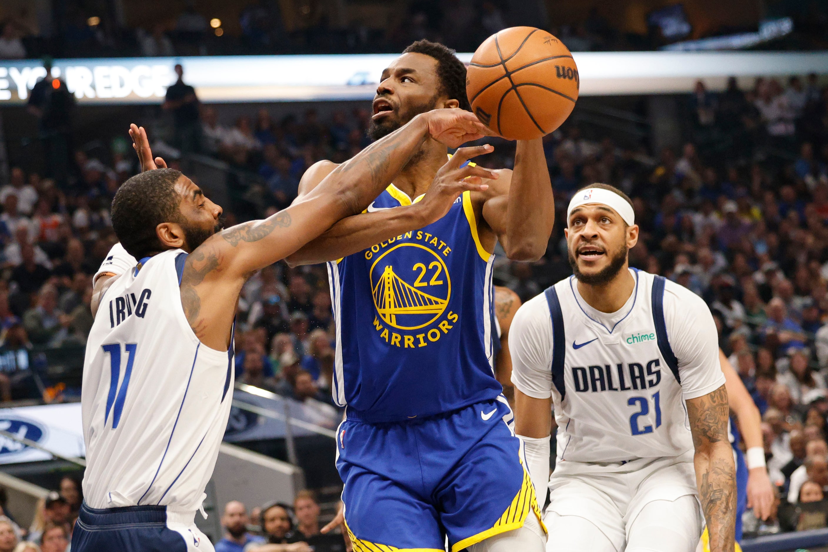 Golden State Warriors forward Andrew Wiggins (22) shoots over Dallas Mavericks guard Kyrie...