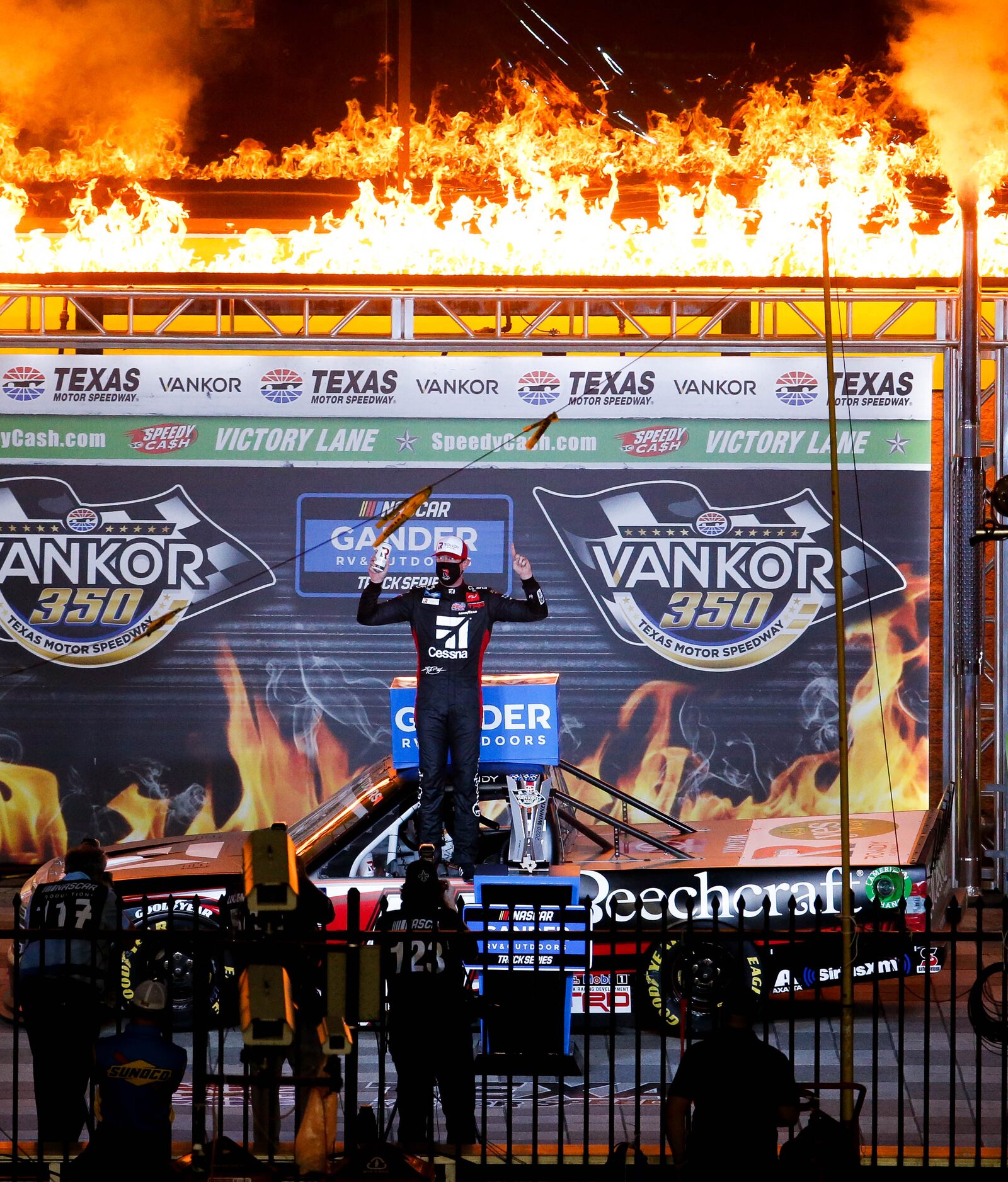 Driver Kyle Busch (No. 51)celebrates in Victory Lane after winning the Vankor 350 NASCAR...