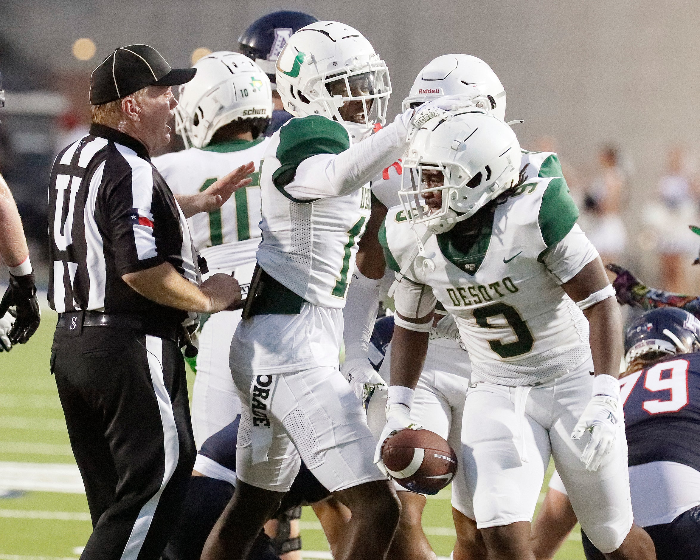 DeSoto High School middle linebacker Jamari Laye (9) is congratulated by DeSoto High School...