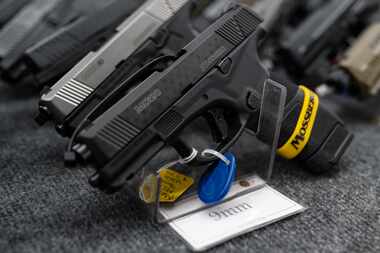 Pistols sat on display at a gun show in Odessa on Jan. 22, 2022.